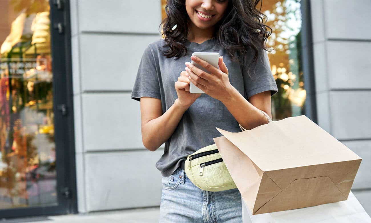 Woman checking her phone for sales notifications